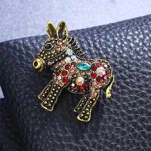 Close-up of a vintage-style donkey brooch featuring vibrant, multicolor rhinestones.