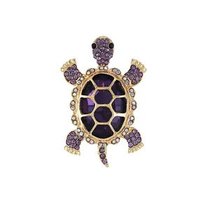 Vintage gold alloy turtle brooch with purple glass crystals and sparkling rhinestones