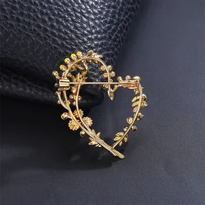 Back view detail of heart shaped mimosa flower brooch with gold finish mechanism