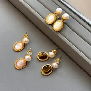Detailed view of vintage palace style oval earrings with pearls and gemstones