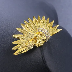 Detailed macro view of a vintage gold Egyptian Pharaoh head brooch with rhinestones