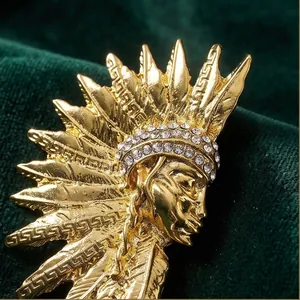 Vintage gold Egyptian pharaoh head brooch with sparkling rhinestones on green velvet