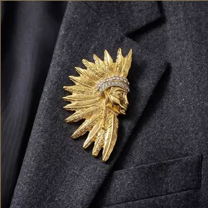 Vintage golden Egyptian pharaoh head brooch with rhinestones on a suit lapel