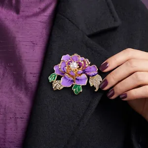 Elegant purple peony flower brooch with central pearl on black coat lapel.