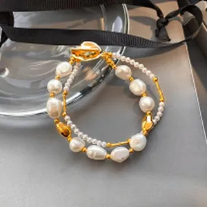 Detail shot of a double-layer baroque pearl bracelet with elegant gold-toned accents