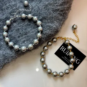 Elegant grey glass pearl bracelets with 24k gold and silver plated metal accents