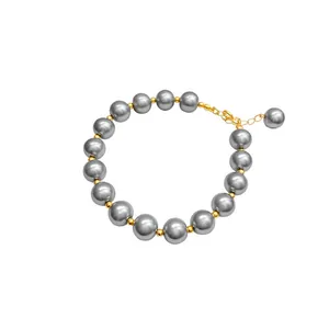 Elegant grey glass pearl bracelet featuring 24k gold plated spacer beads and adjustable clasp