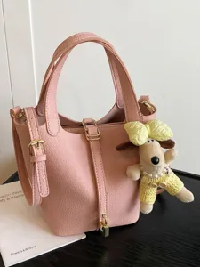 Elegant pink leather bucket bag with dog pendant for women's summer crossbody use