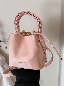 Stylish pink marble-textured bucket bag with a unique braided handle for women's fashion