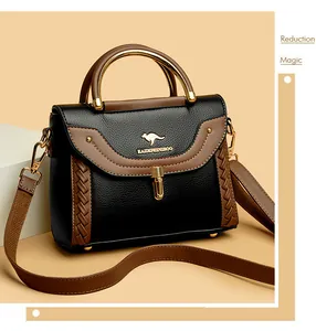 Elegant black and brown crossbody bag with woven detail and gold-tone metal handle