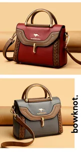 Close-up of contrast color crossbody bags with metallic handles and woven details