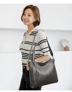 Large capacity grey leather shoulder bag for women shown on an elegant Asian model