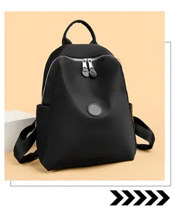 Detail view of a black waterproof nylon backpack for women on a beige background