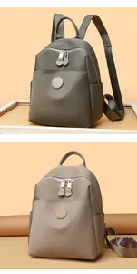 Detailed view of fashionable waterproof nylon backpacks in two neutral colors.