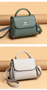 Detailed view of fashion women's handbags in green and beige with top handles.
