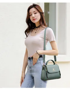Fashionable dark green leather crossbody handbag for women featuring a golden kangaroo logo