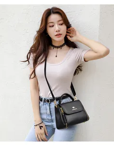Elegant black leather crossbody handbag for women styled with a casual outfit