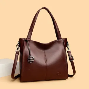Stylish brown leather large capacity shoulder bag for women with multi-compartment design.