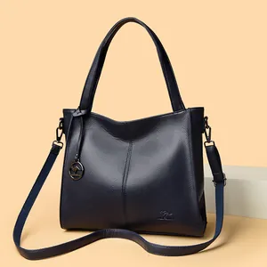 Navy blue pebbled leather tote bag with kangaroo logo and adjustable shoulder strap
