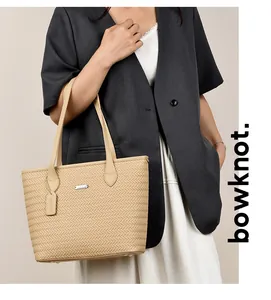 Model carrying a beige woven texture PU leather tote bag for professional look