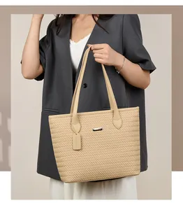 Detailed view of a woman carrying a beige woven pattern PU leather tote handbag