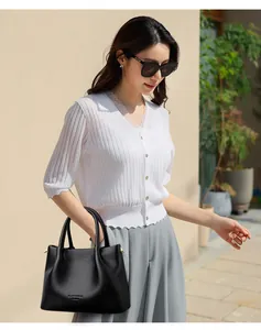 Elegante bolso de mano de cuero negro para mujer en un entorno de estilo de vida urbano