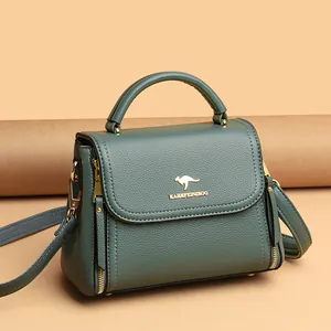 Elegant teal leather handbag with kangaroo logo and crossbody strap for women.
