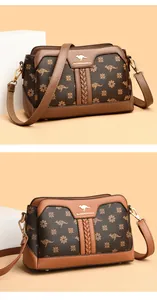 Elegant brown crossbody bag with floral and kangaroo print and gold-tone logo.