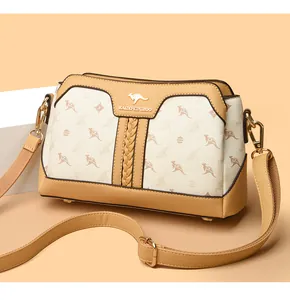 Detail view of the elegant beige printed handbag with gold-tone hardware and adjustable strap