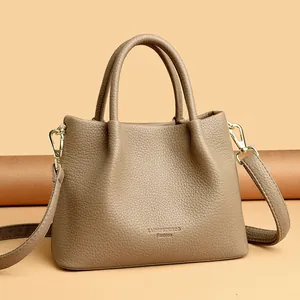 Bolso de mano elegante en cuero granulado con asas y herrajes dorados en taupe