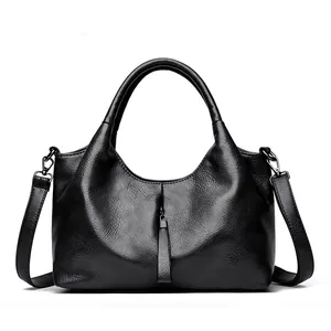 Black leather shoulder bag for women, stylish hobo handbag with top handles and strap.