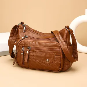Bruine crossbodytas van zacht kunstleer voor dames met meerdere ritscompartimenten