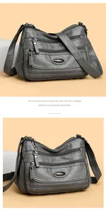 Large capacity grey washed leather crossbody bag with multiple zipper pockets.