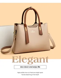 Elegante borsa in pelle PU beige con manici marroni e dettagli hardware dorati.