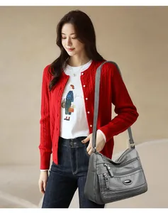 Detailed view of large capacity grey washed leather shoulder bag carried by Asian model