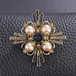 Elegant vintage gold alloy brooch with pearls and sparkling rhinestones for classic suit styling