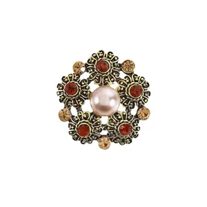 Vintage floral brooch with central pearl and colorful rhinestones on bronze base