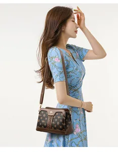 Detail shot of an elegant brown patterned crossbody bag worn by a professional model