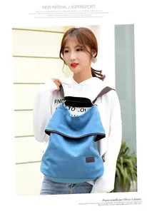 Stylish blue canvas multi-functional bag worn as a backpack by a young female model.
