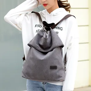 Stylish charcoal grey canvas backpack for women with multi-way straps worn by a model
