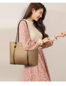 Bolso tote grande de cuero marrón para mujer mostrado con un elegante traje floral
