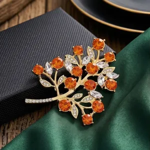 Elegant gold alloy fruit tree brooch with sparkling orange and clear rhinestones.