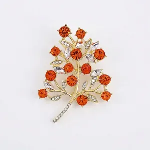 Elegant orange crystal fruit tree brooch with gold-plated alloy and rhinestones.