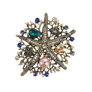 Elegante broche de estrella de mar vintage con diamantes de imitación y perla rosa