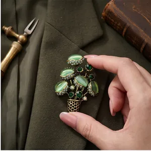 Elegant vintage flower basket brooch with green cat's eye stones on a blazer lapel