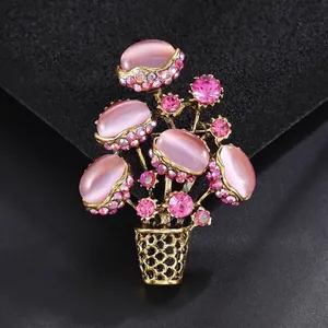 Vintage gold alloy flower basket brooch with pink cat-eye stones and rhinestones