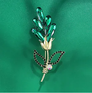 Detailed macro view of high-end rose flower brooch with emerald green glass and black rhinestones