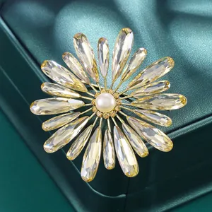 Elegant sunflower brooch with yellow K9 glass petals and natural freshwater pearl center