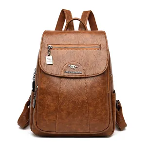 Elegant brown faux sheepskin leather backpack for women with kangaroo logo detail and zipper