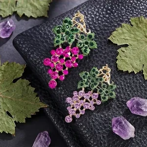 Elegant grape cluster brooches with sparkling crystals in pink and purple finishes.